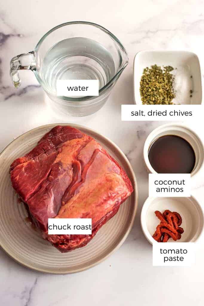 Ingredients to make pulled beef in white bowls.