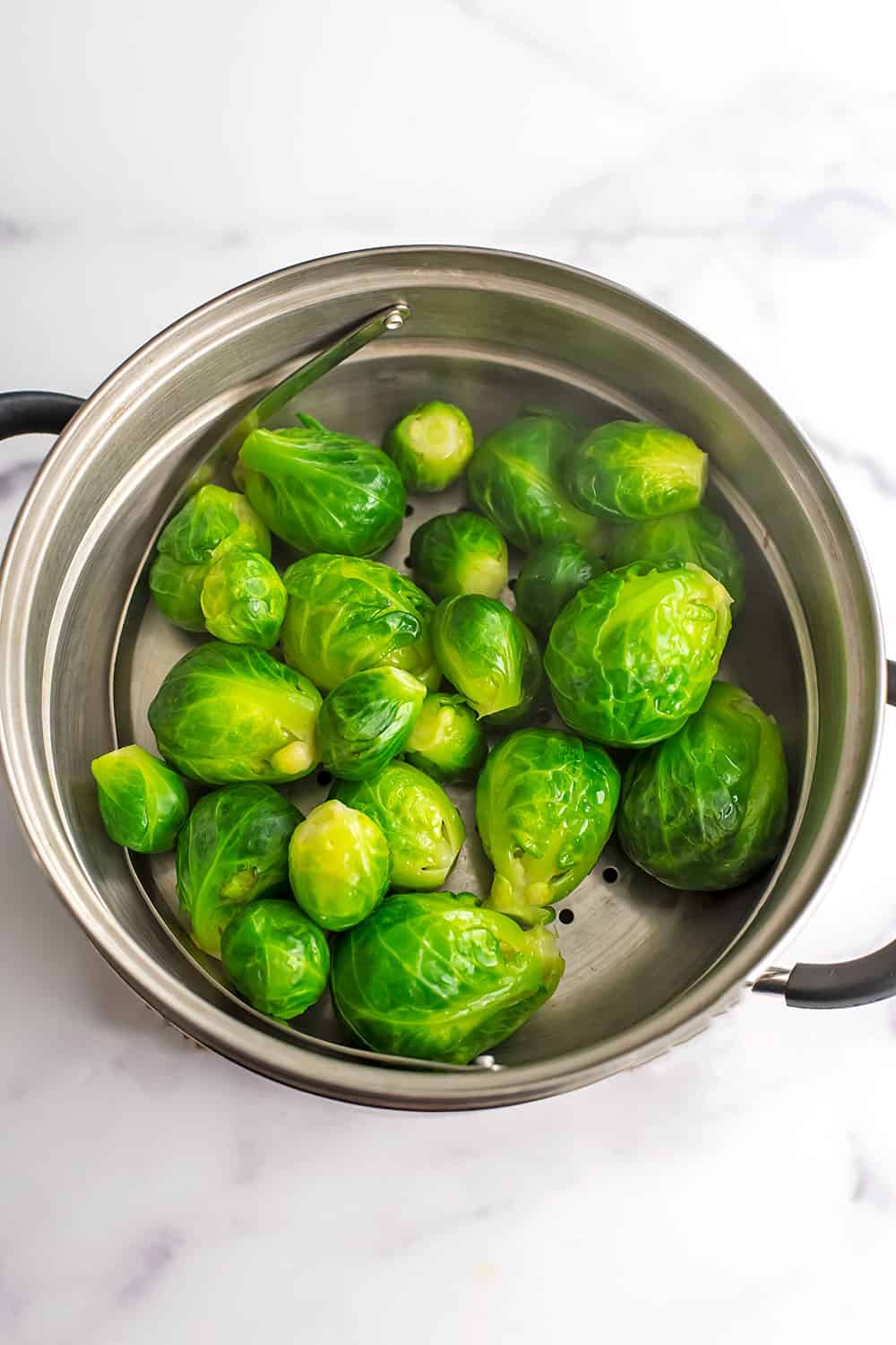 Brussel sprouts in steamer basket after steaming.