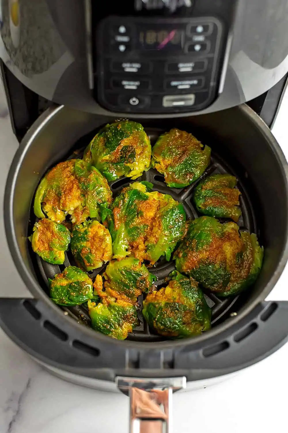 Smashed brussel sprouts coated in turmeric spice blend.