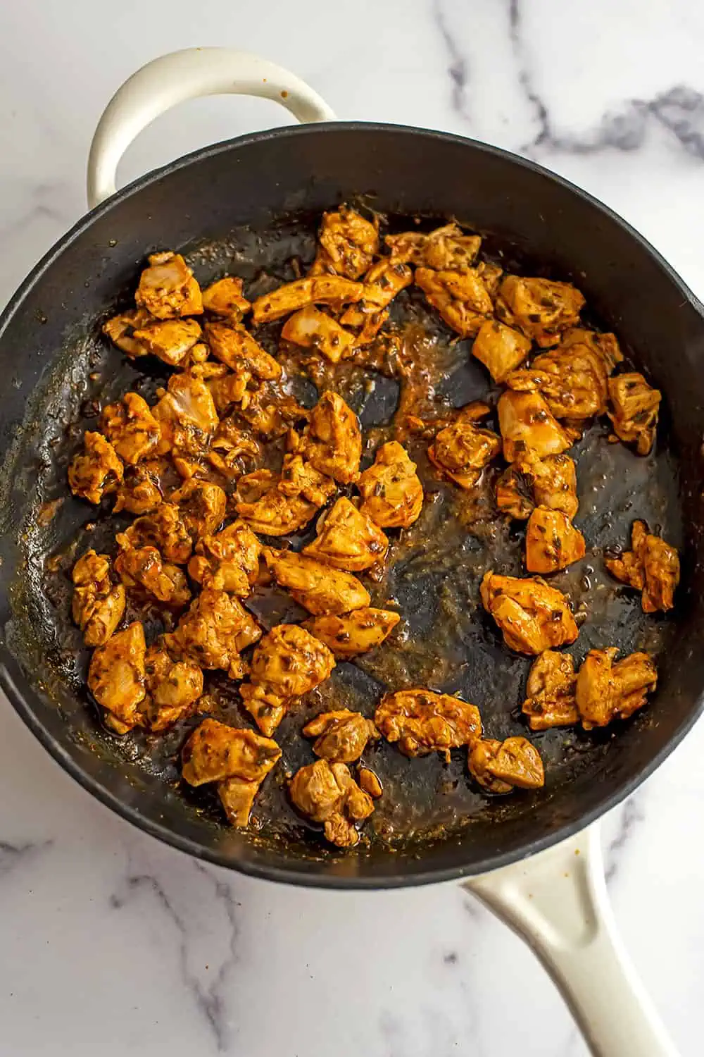 Buffalo chicken bites in large cast iron skillet.