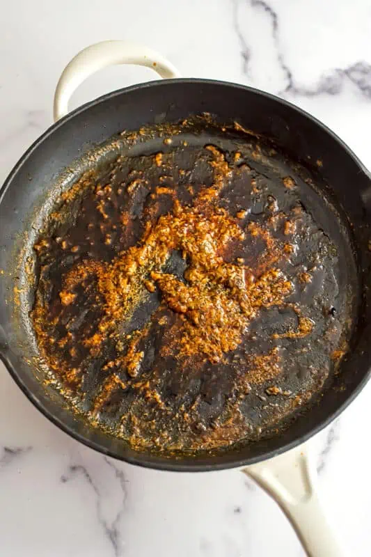 Buffalo sauce after reducing on the stove in skillet.
