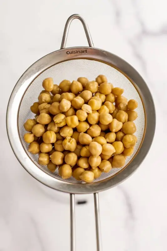 Chickpeas in a mesh strainer.