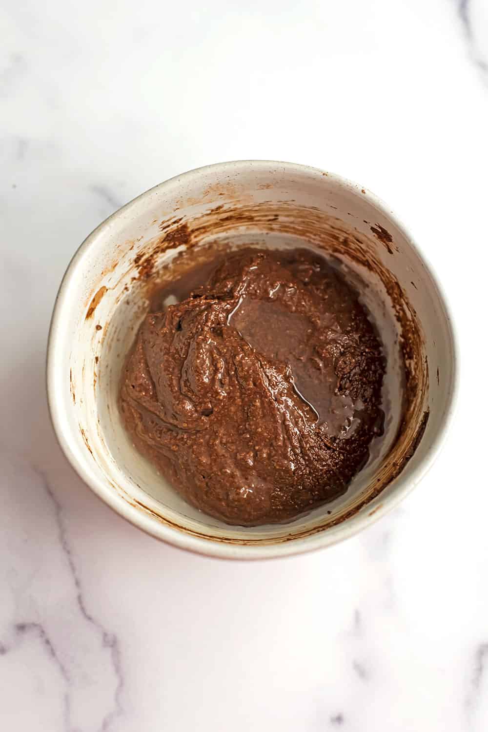 water added to bowl with chocolate tahini spread.