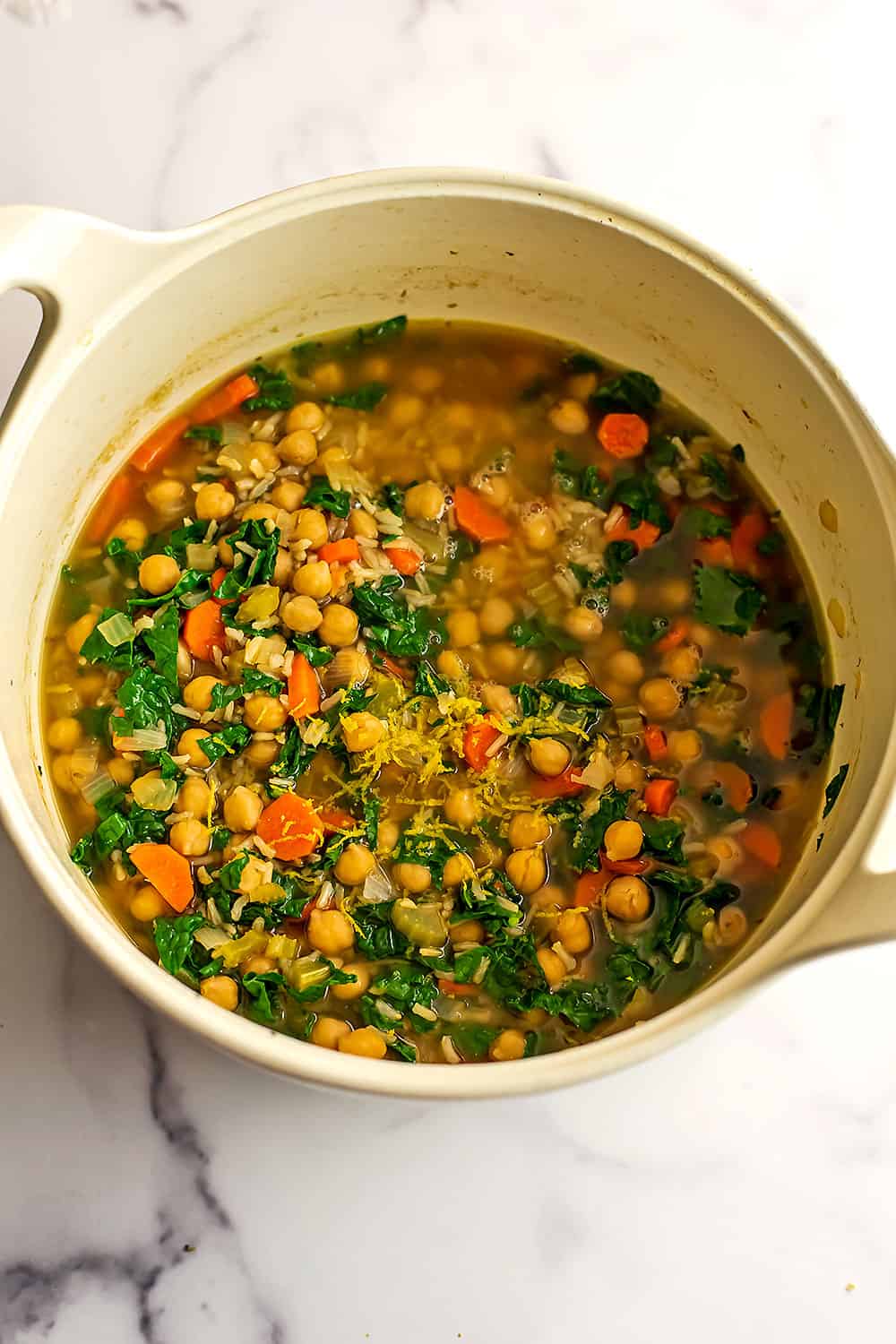 Vegan chickpea soup in a large white pot.