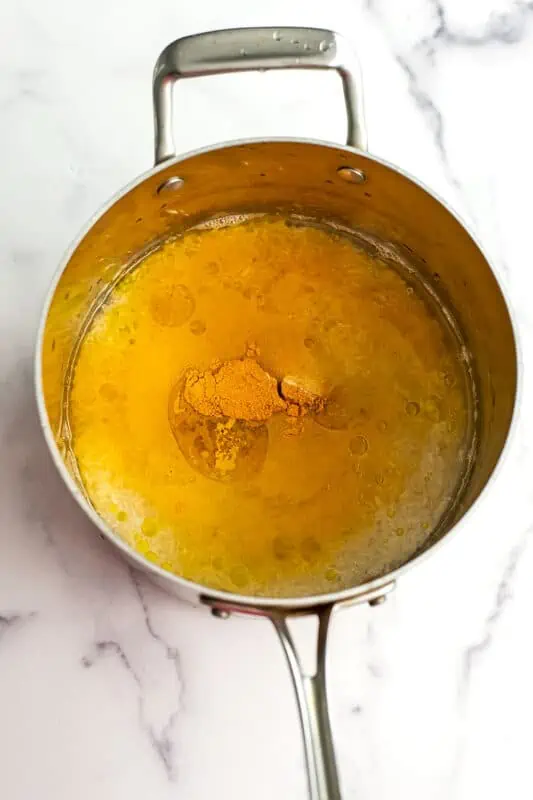 Turmeric and garlic powder added to water with rice.