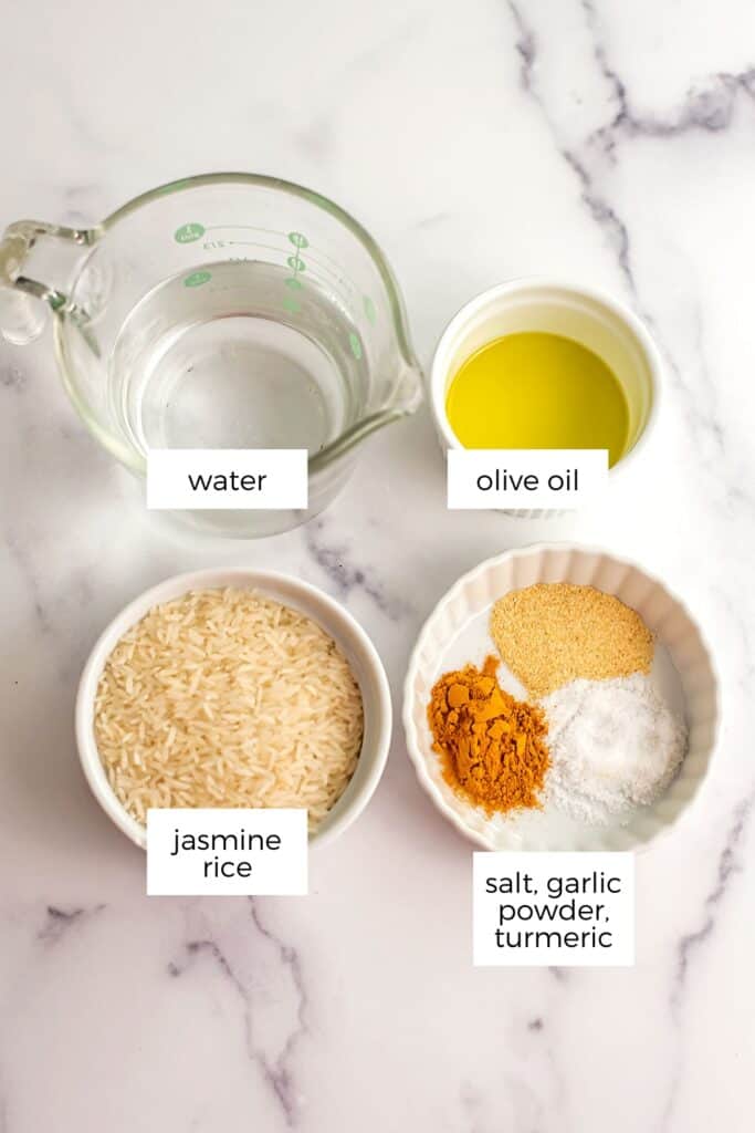 Ingredients to make turmeric garlic rice in ramekins.