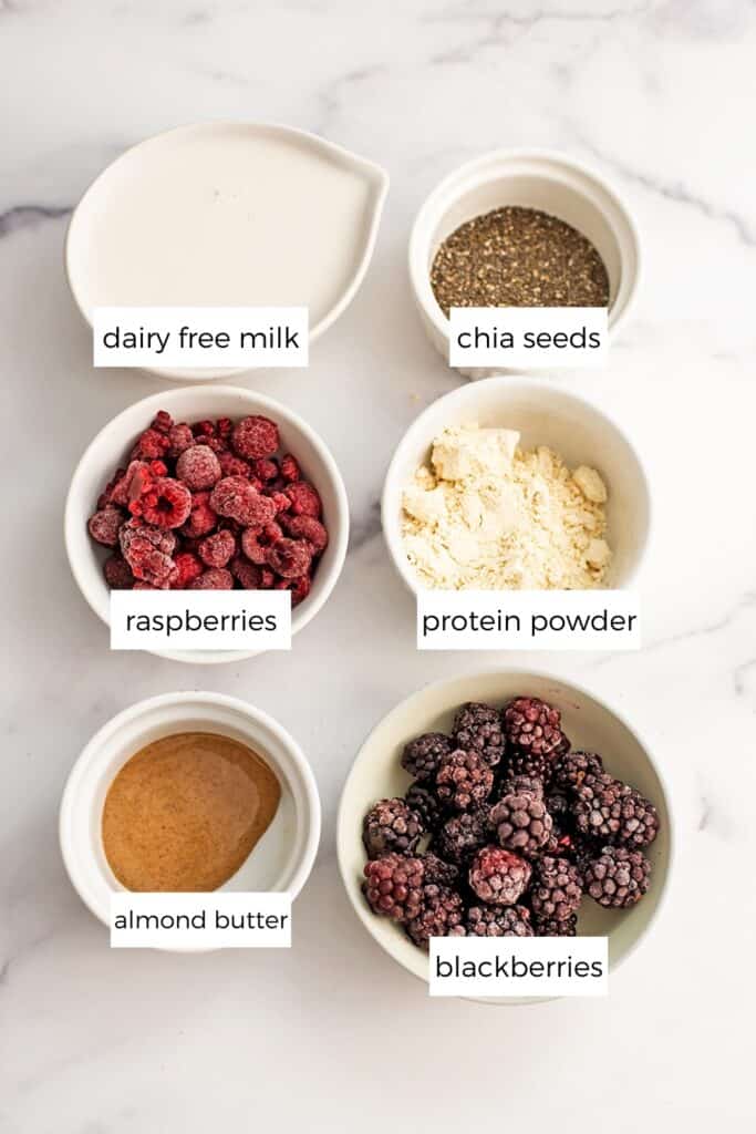 Blackberry Raspberry Smoothie ingredients separated in to white ramekins. 
