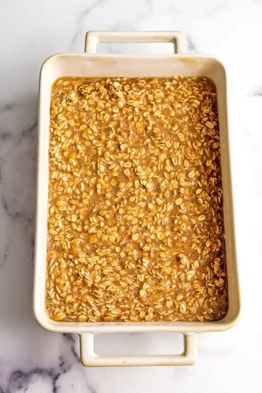 Banana bread baked oats in casserole dish before baking.