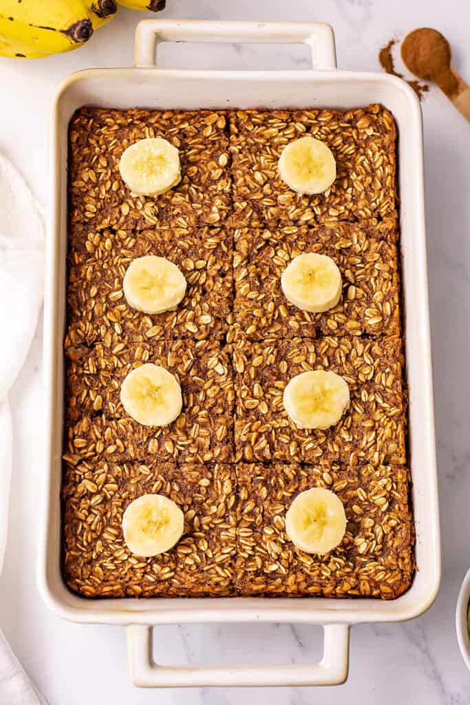 Banana bread baked oatmeal with sliced bananas on top.