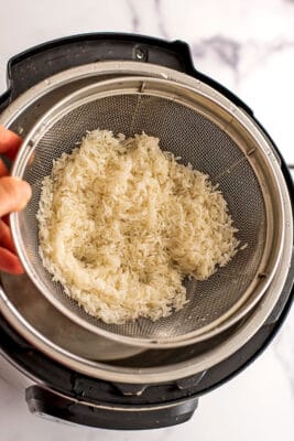 Rice in mesh strainer.