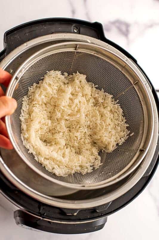 Rice in mesh strainer.