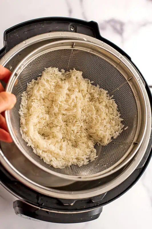 Rice in mesh strainer.