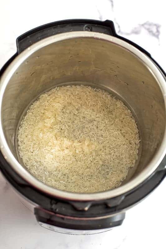 Water and rice in instant pot before cooking.