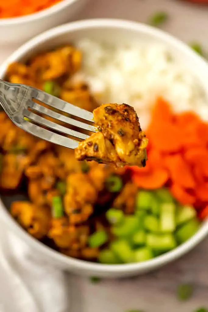 Fork holding buffalo chicken bite over a bowl.