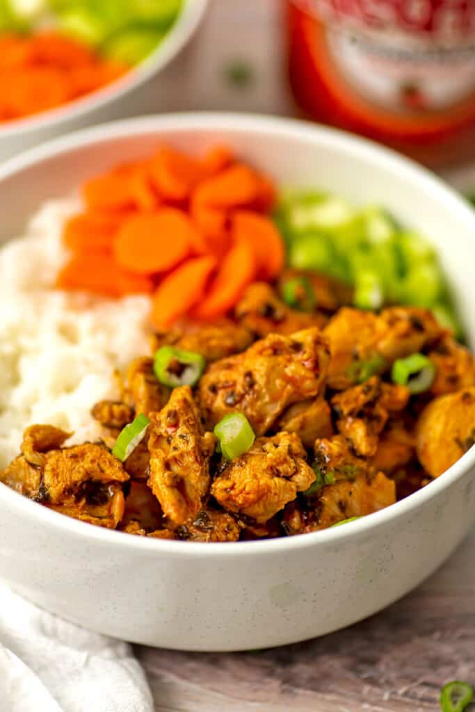 Buffalo chicken in bowl with rice and veggies.