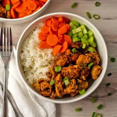White bowl filled with buffalo chicken and rice.