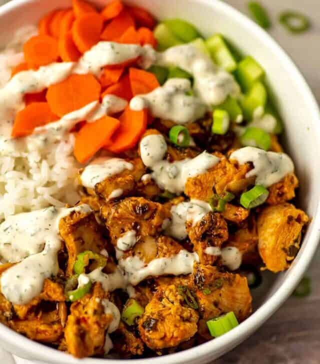 Ranch dressing drizzled over buffalo chicken rice bowl.