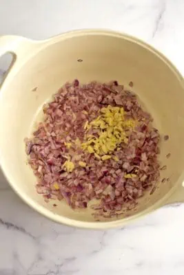 Sauteed red onion and garlic in a large pot.