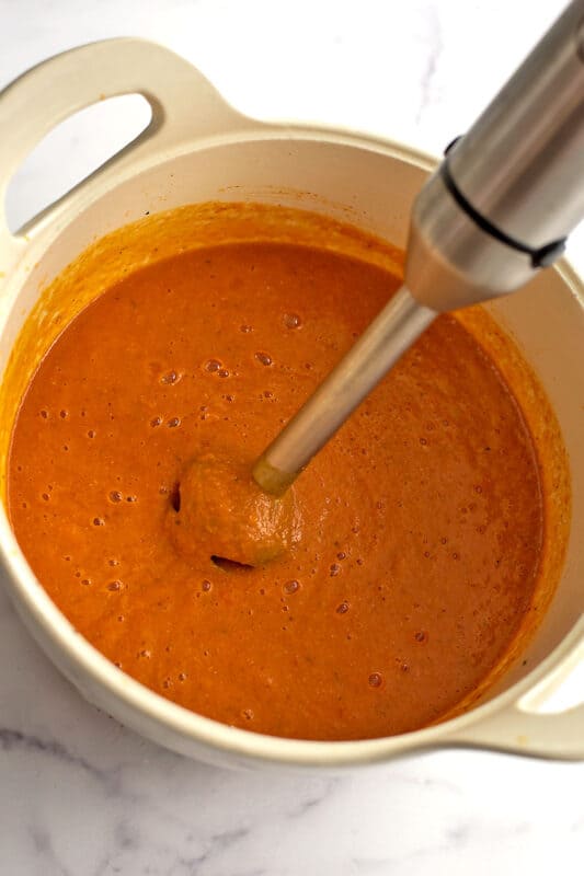 Immersion blender blending up the red pepper lentil soup.