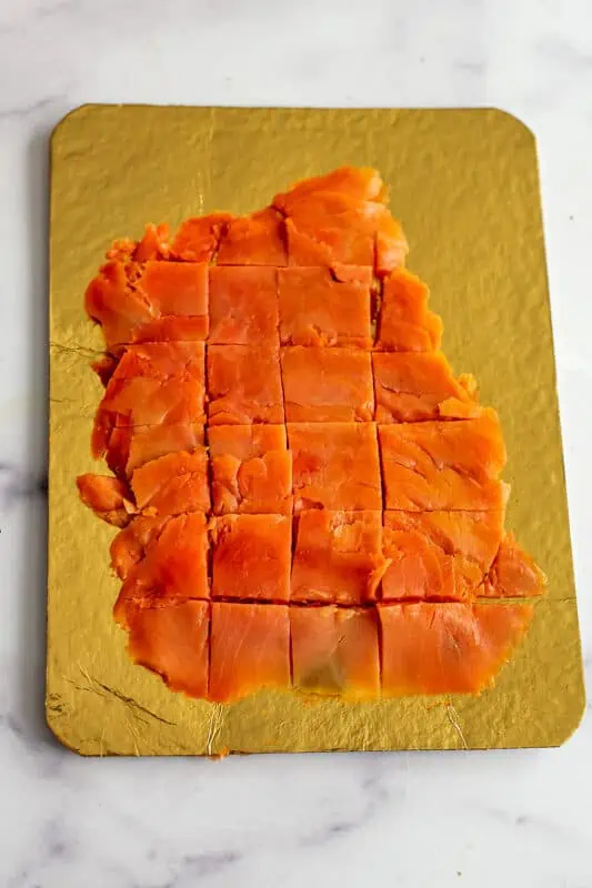 Smoked salmon cut into squares.