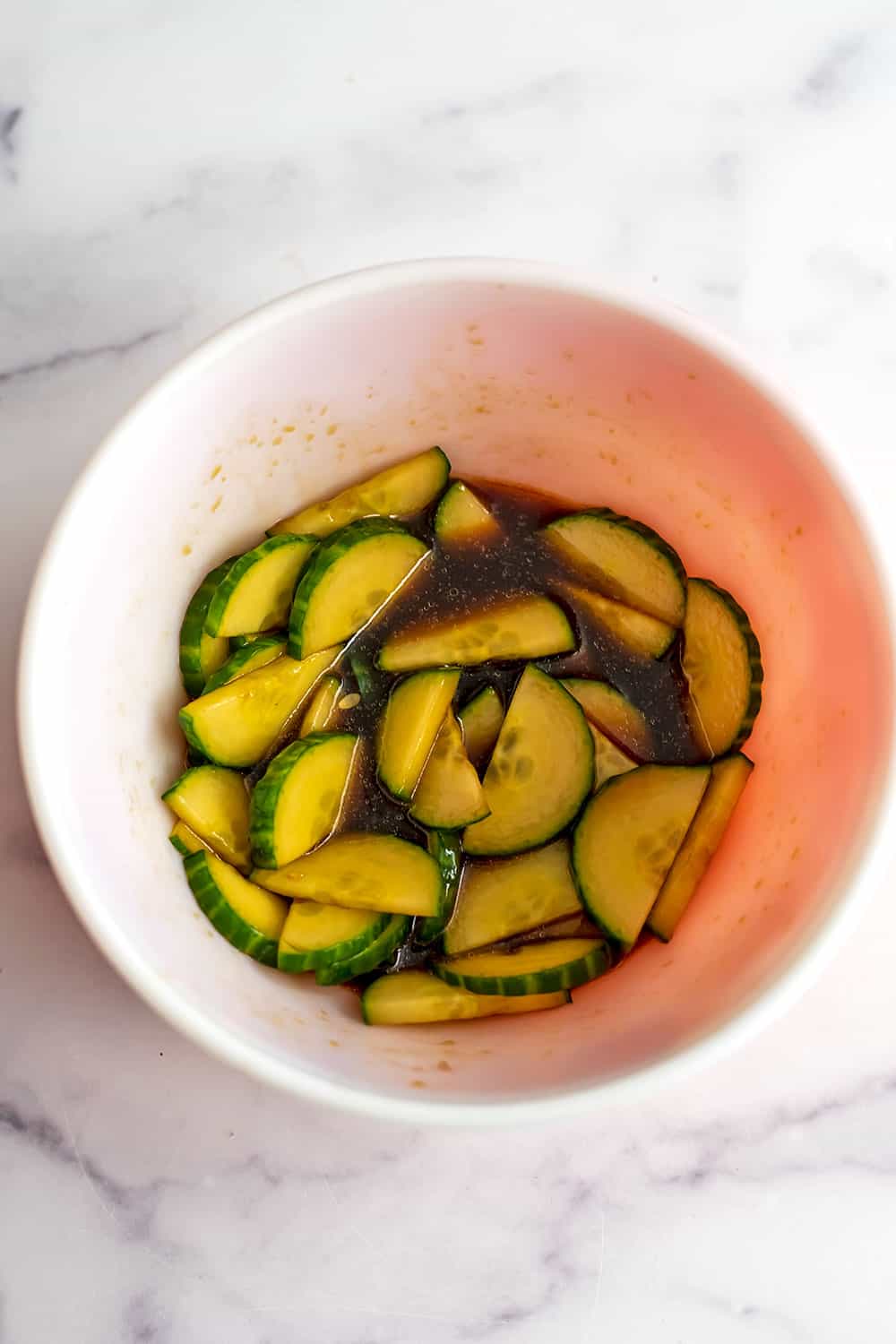 Marinated cucumbers in a bowl.