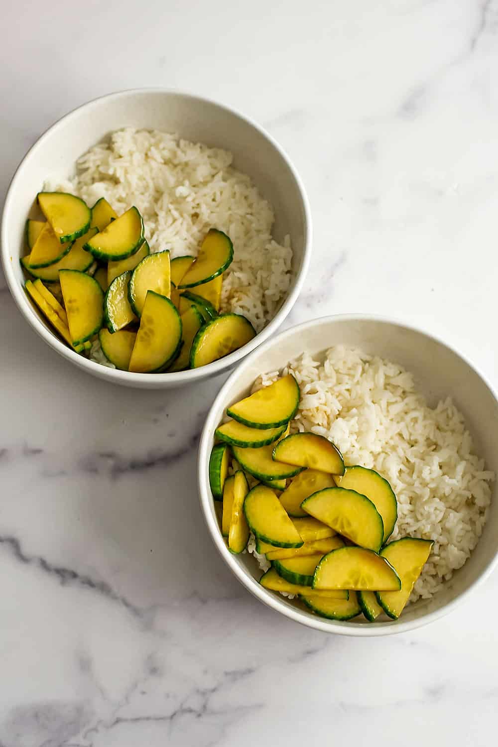 Marinated cucumber in a bowl with rice.