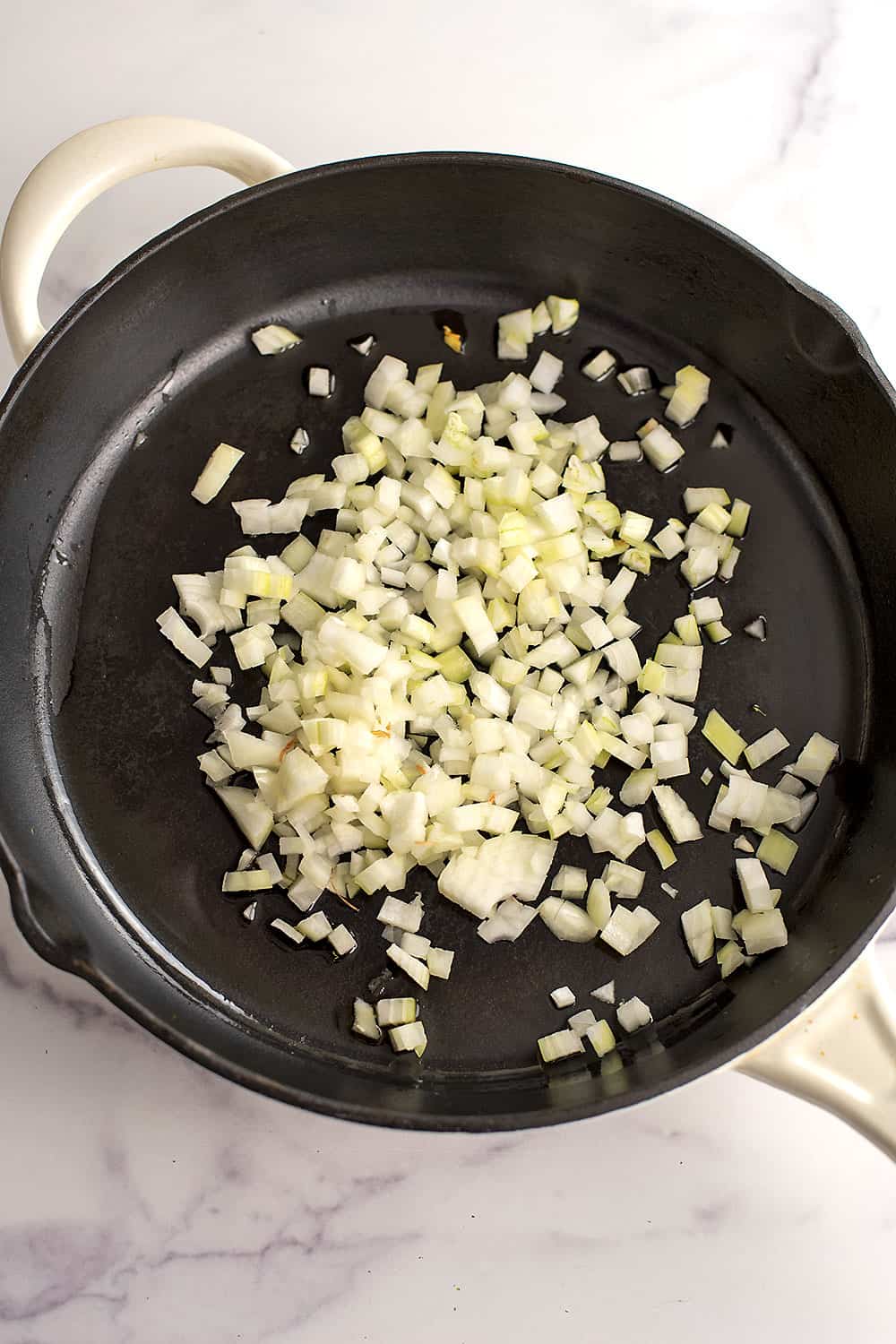 Diced onions added to skillet.