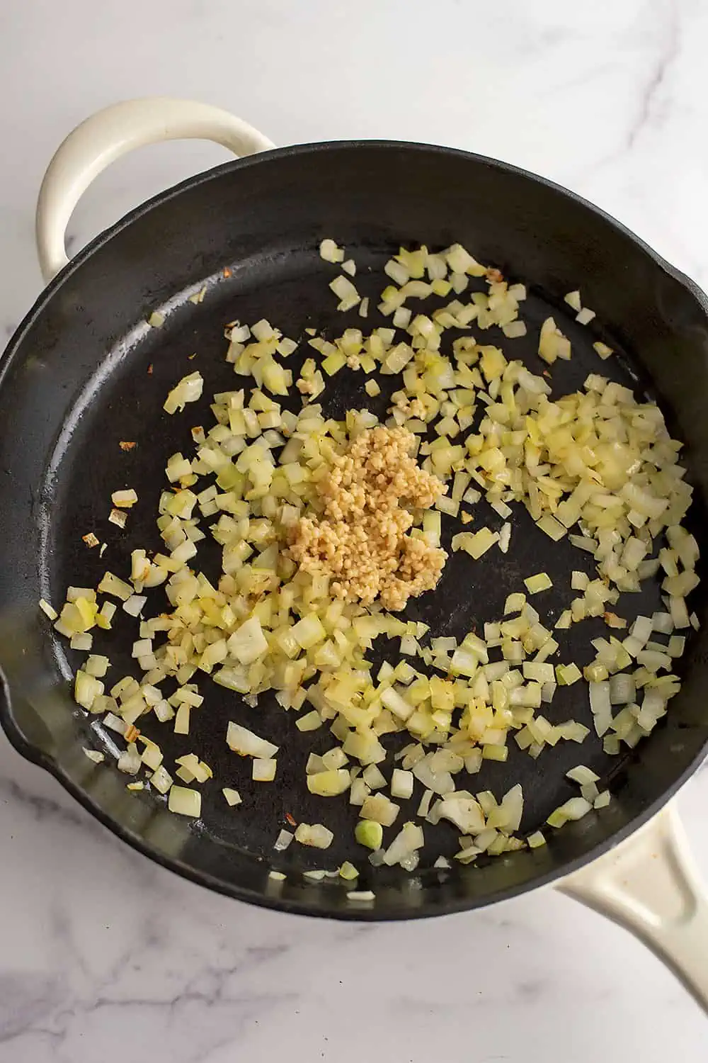 Chopped garlic added to skillet with cooked onions.