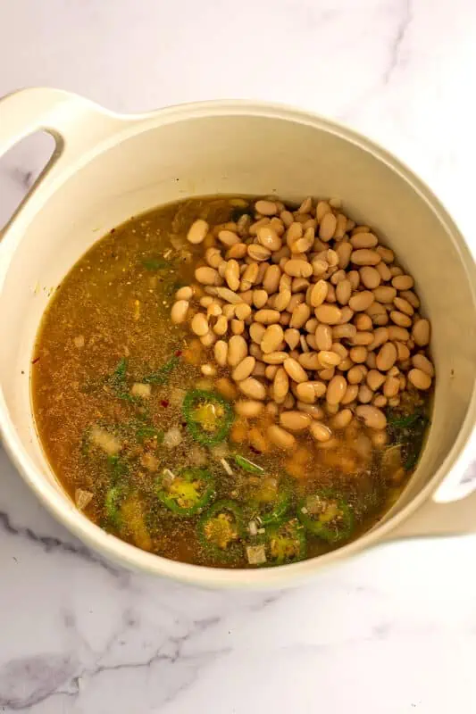 White beans and green peppers in a pot.