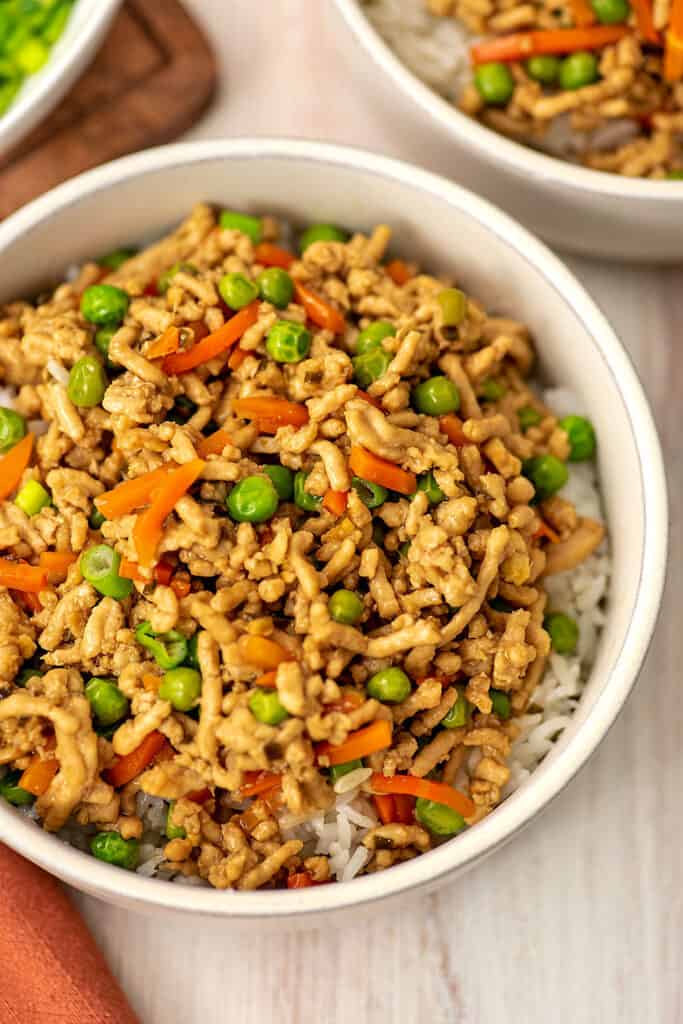 White bowl filled with teriyaki ground chicken and rice.