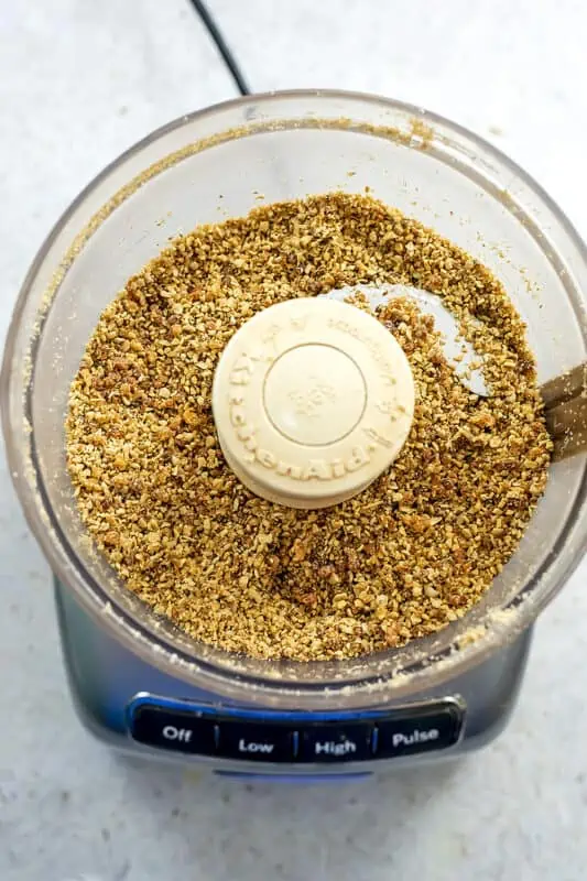 Carrot cake protein ball ingredients in food processor after processing.
