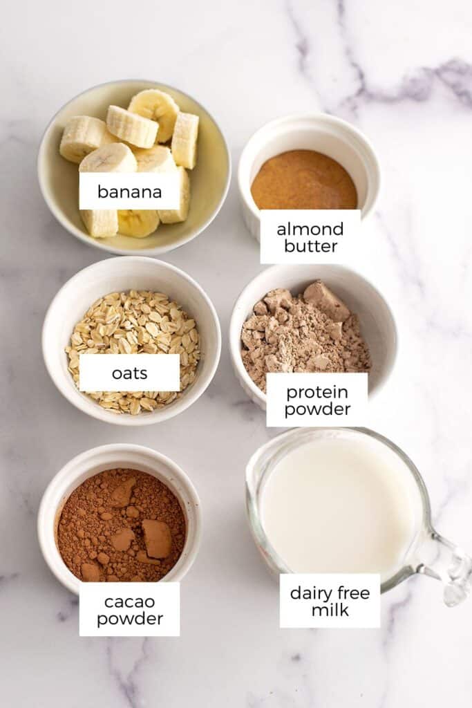 Chocolate oat smoothie ingredients in white ramekins.