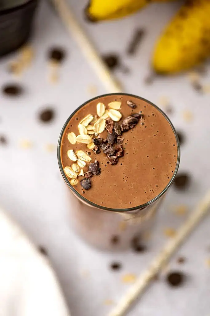 chocolate smoothie without bananas with oats and cacao nibs on top.