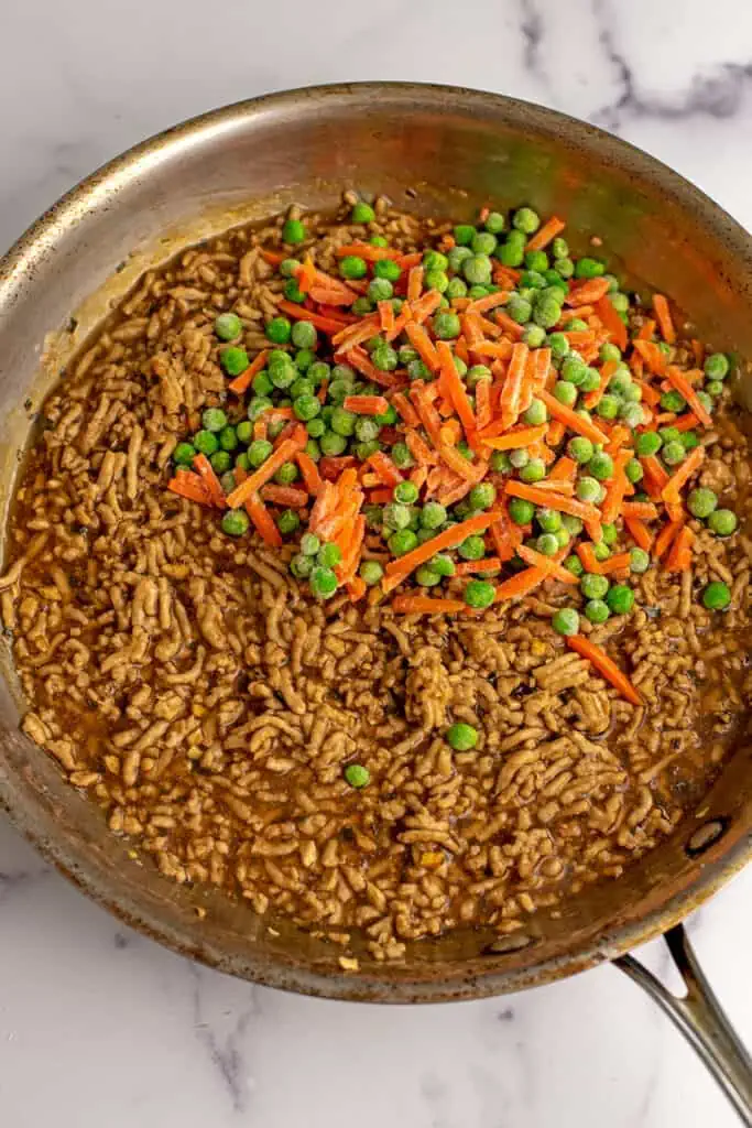 Frozen peas and carrots added to asian ground chicken.