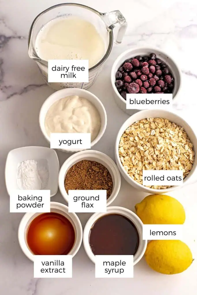 Ingredients to make lemon blueberry oatmeal on a marble countetop.