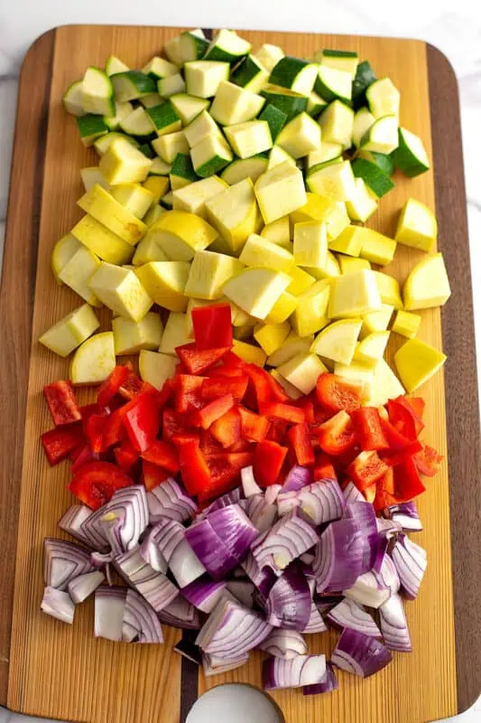 Chopped vegetables on a wood cutting board.
