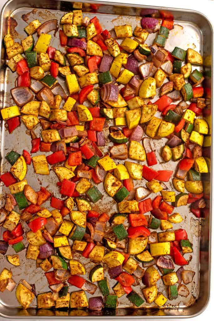 Sheet pan full of Mexican veggies after roasting.