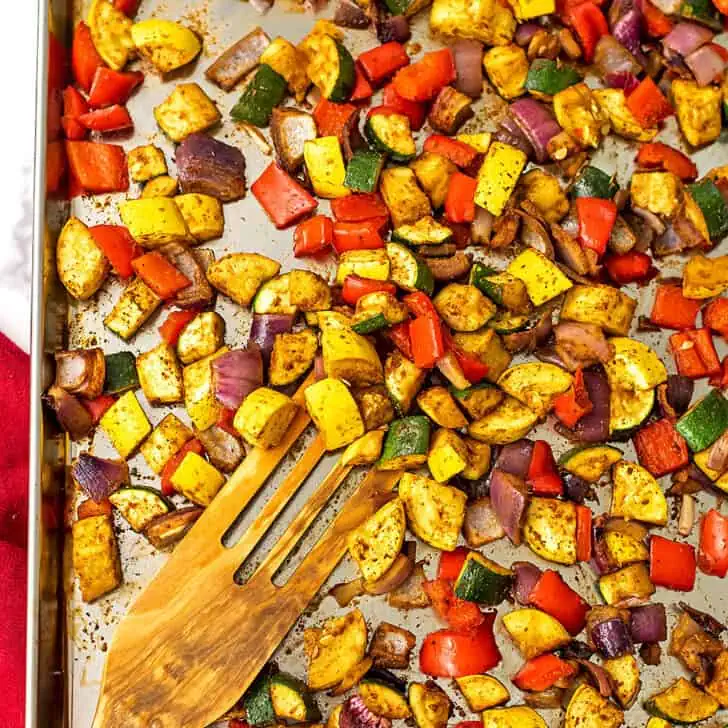 Mexican roasted vegetables on large silver sheet pan.