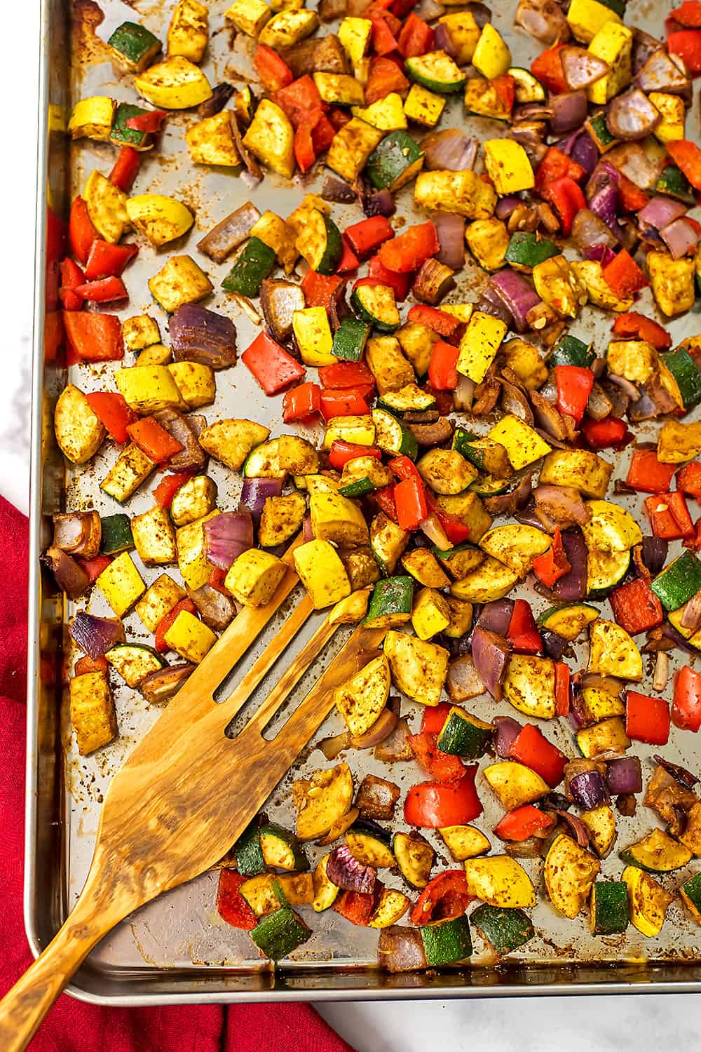 Mexican roasted vegetables on large silver sheet pan.