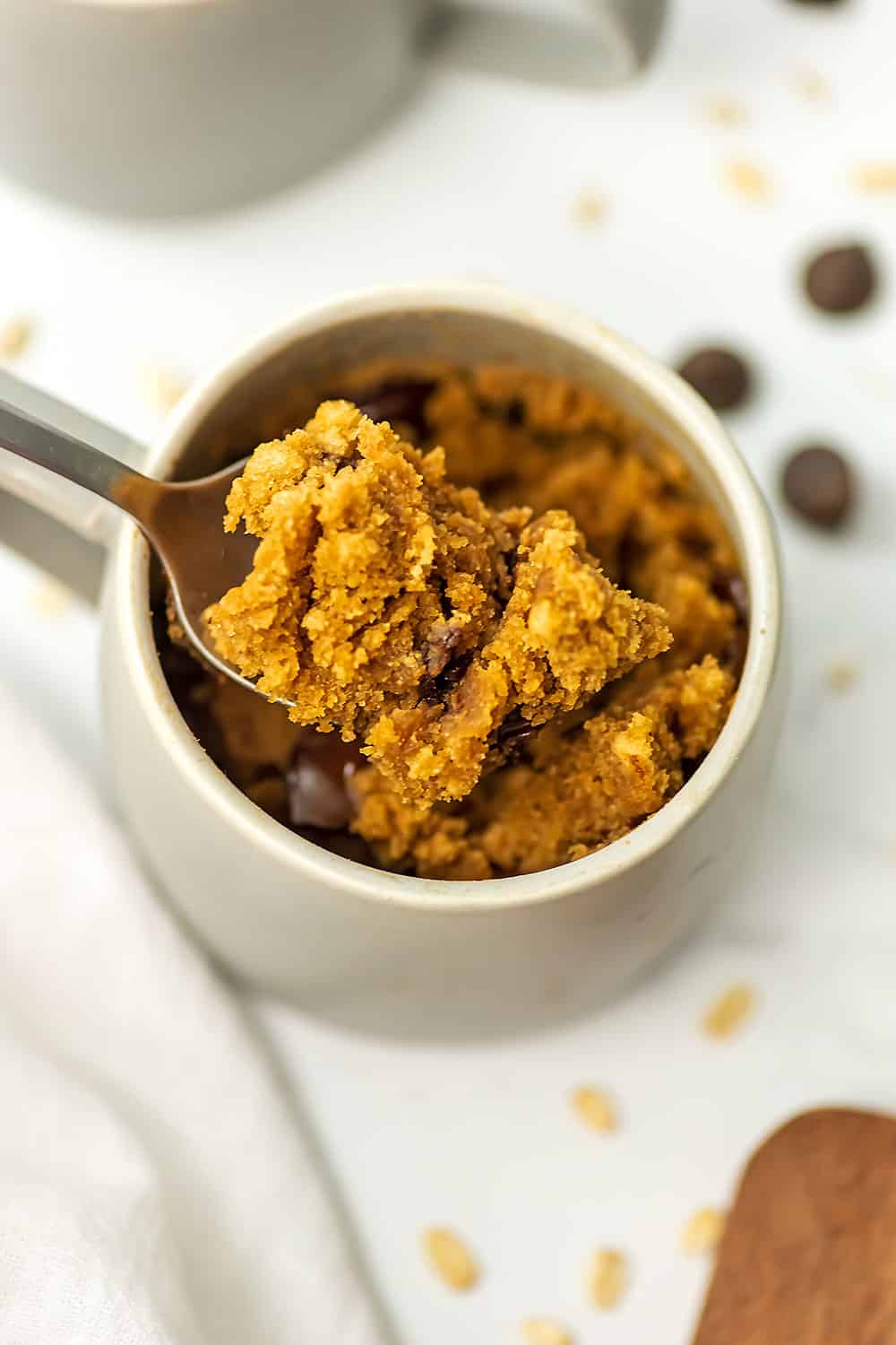 Spoonful of oat flour mug cake being spooned out of the mug.