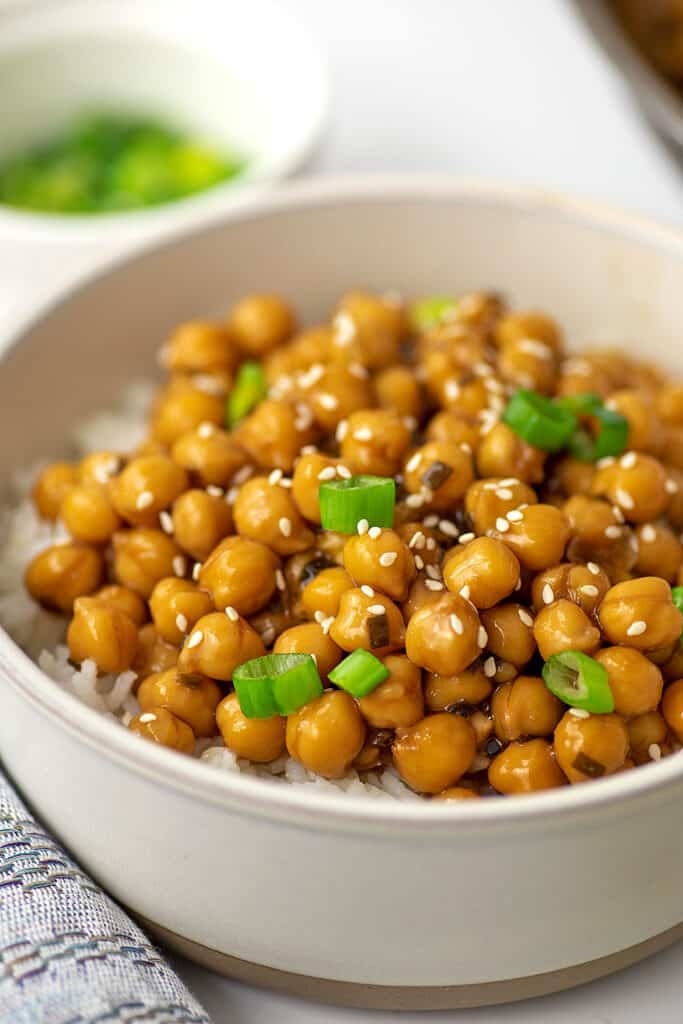 Bowl filled with teriyaki chickpeas on white rice.