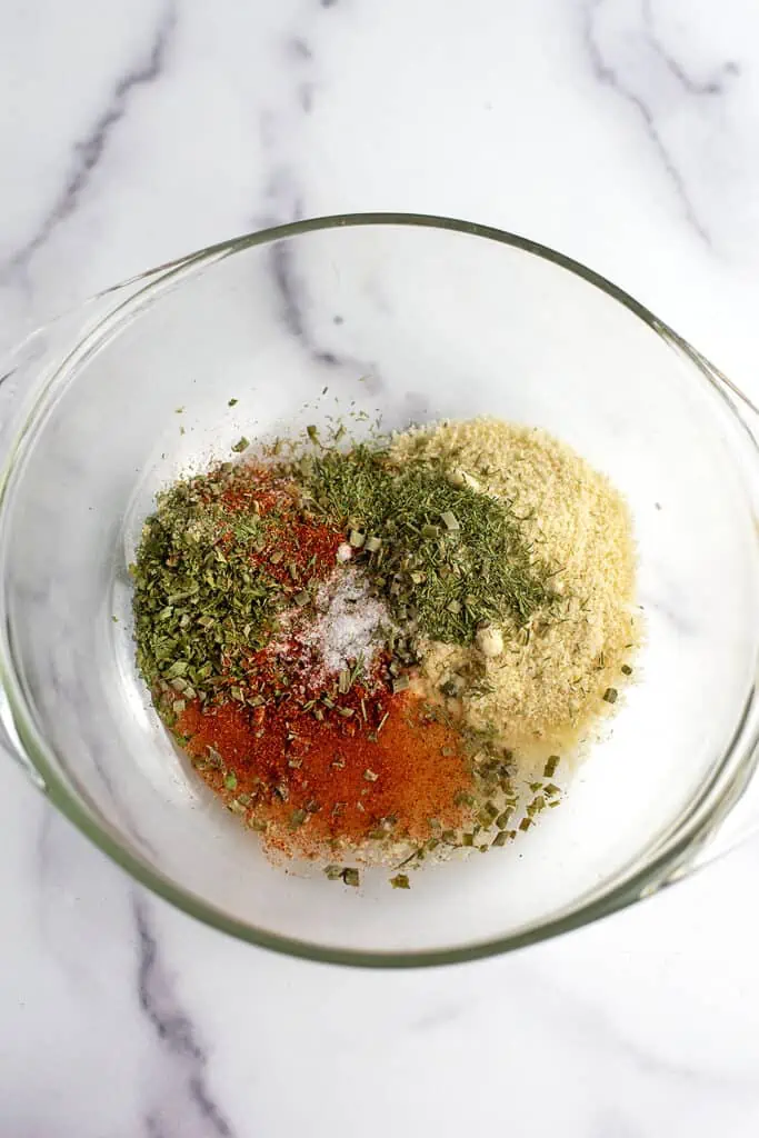 Spices and almond flour in glass bowl.