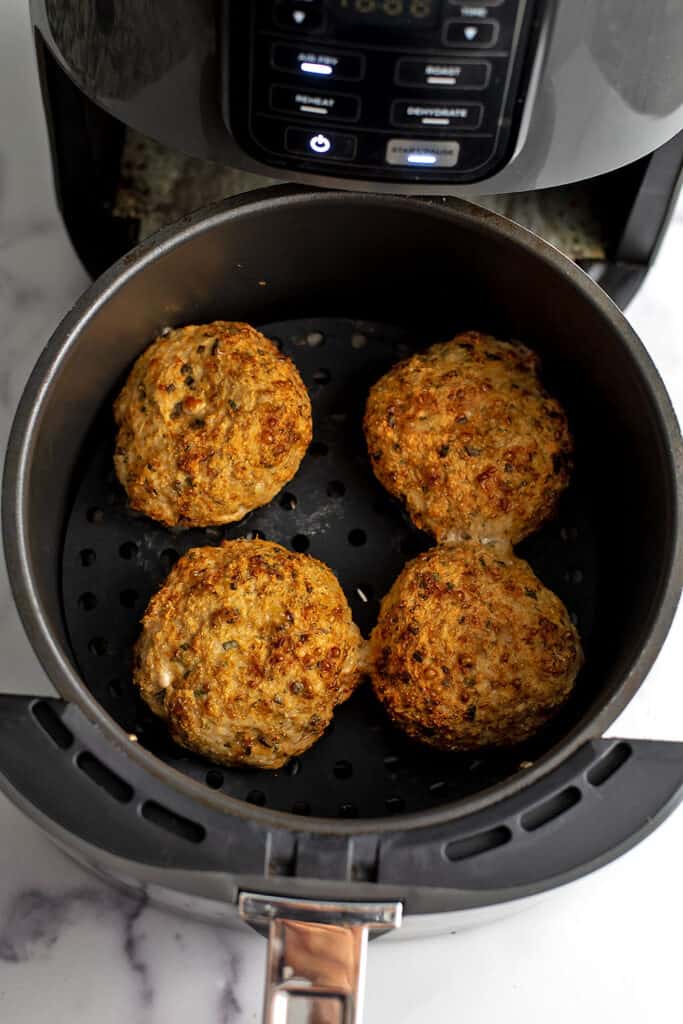 Chicken burgers in air fryer after cooking.