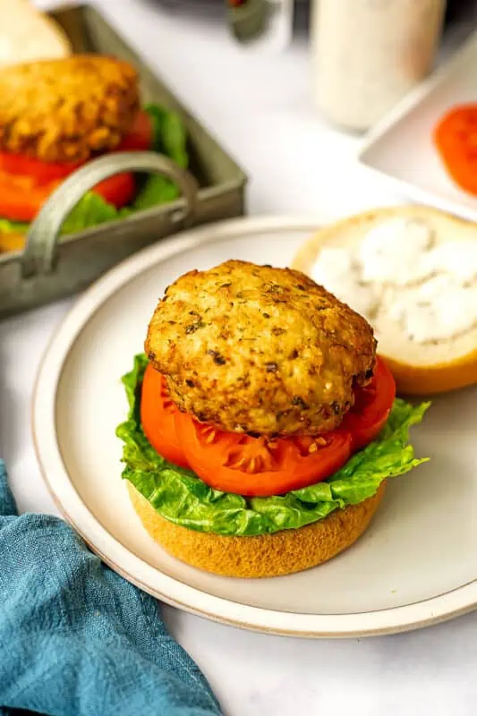 Air fryer chicken patty on a bun with lettuce and tomato.