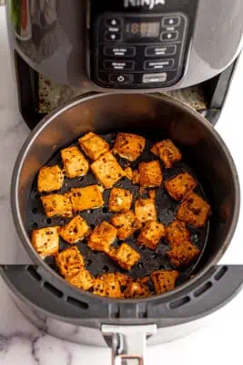 Salmon bites in air fryer after cooking.