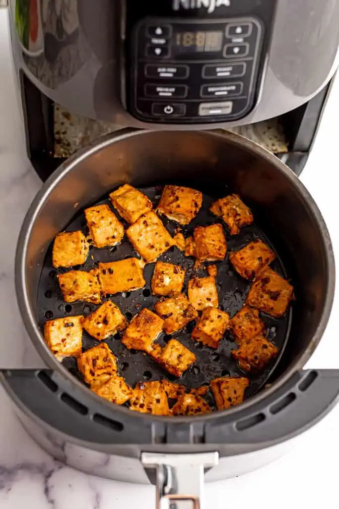 Salmon bites in air fryer after cooking.