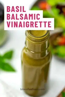 Glass bottle filled with basil balsamic vinaigrette.