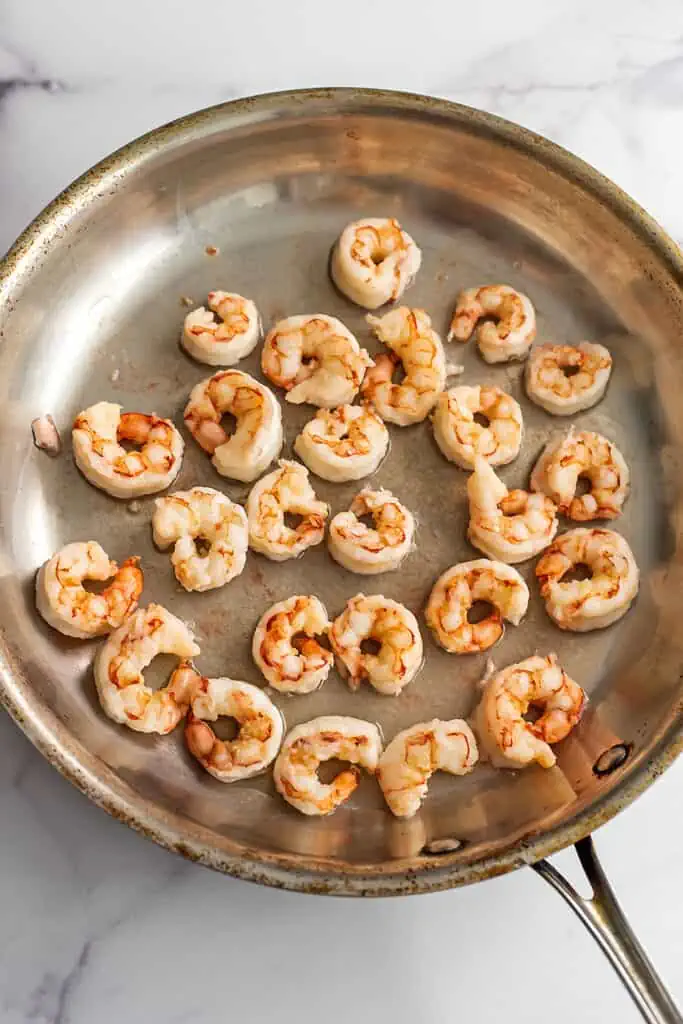 Shrimp in stainless steel skillet after cooking.