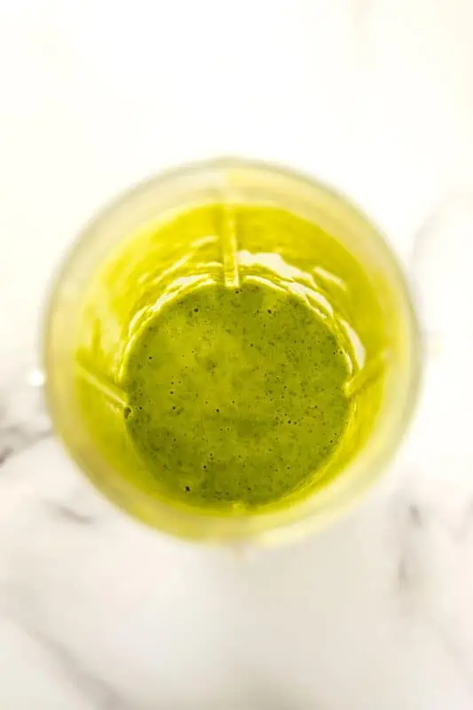 Mango kale smoothie after blending in blender cup.