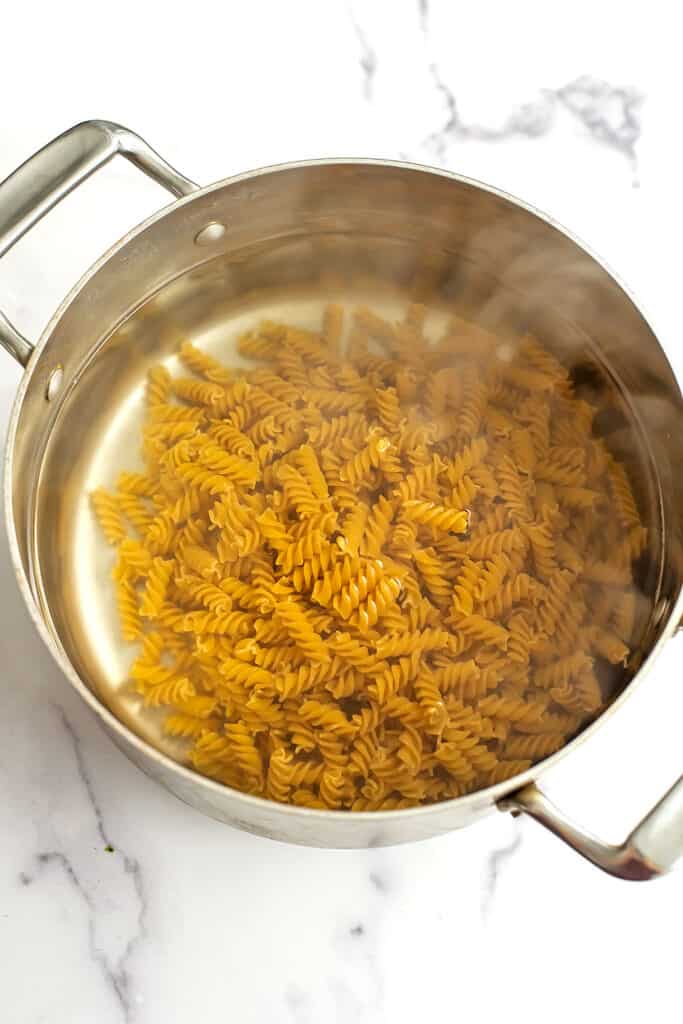 Pasta added to pot of boiling water.